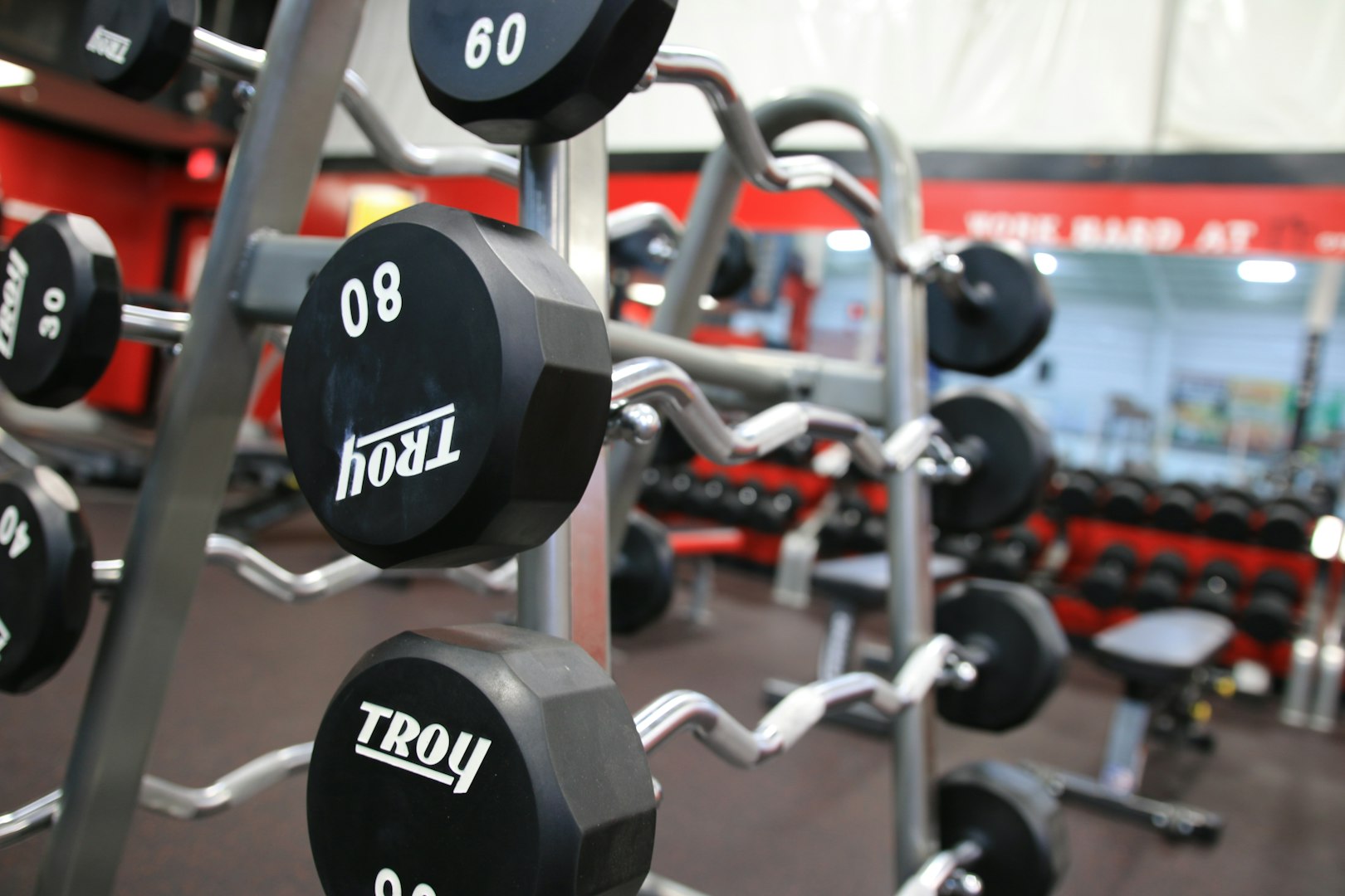 a gym filled with black and silver dumbs